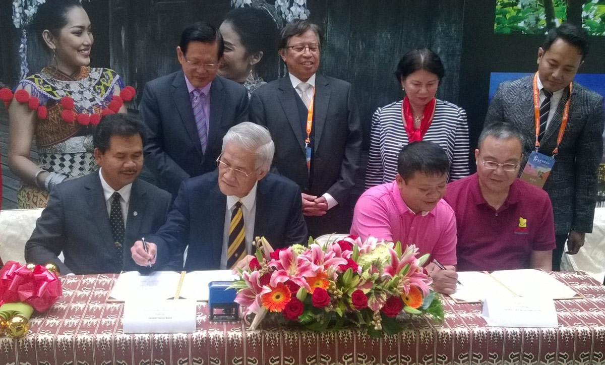 Picture shows Datuk Wahab seated second from left, flanked by Mr. Mark Chen on his left signing the MOU witnessed by Datu Ik seated at left and Mr. Chen (right). Also seen standing from left, Datuk Lee, Datuk Amar Abang Johari, Datuk Adeline and Ahmad Faisal.